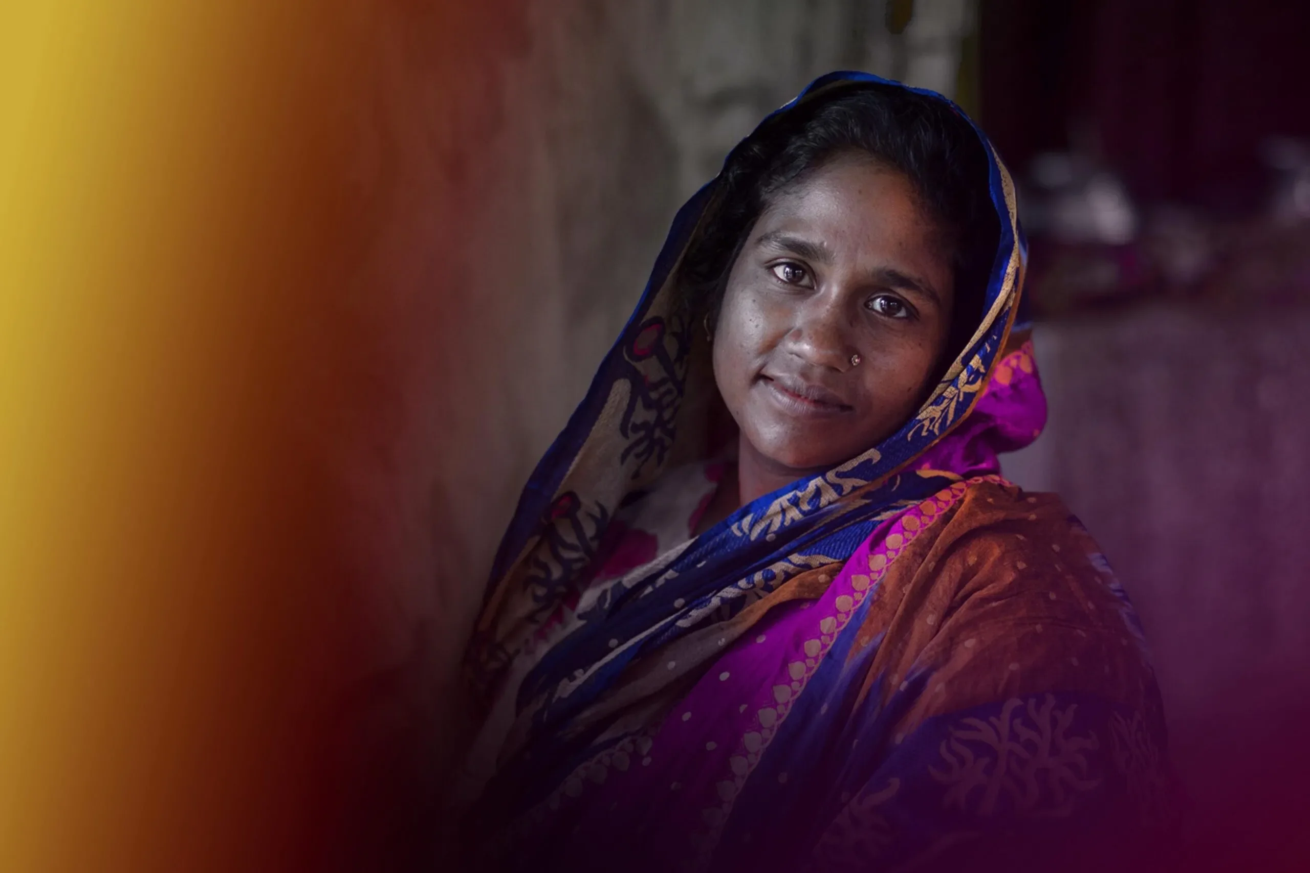 A portrait of a woman wearing a multicolored headscarf.