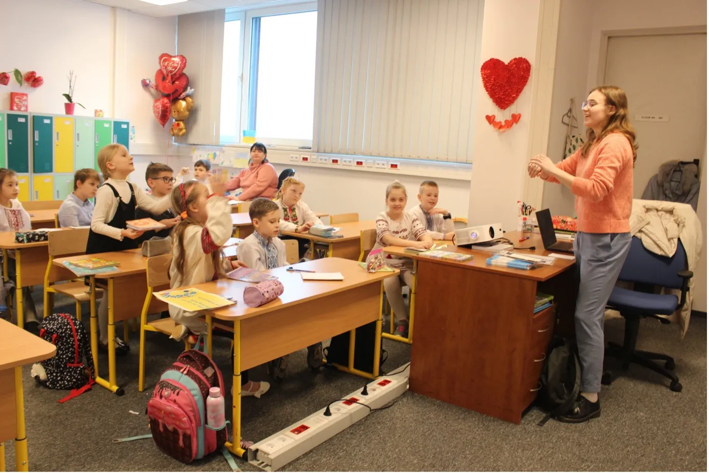Photo of young children and teacher in a classroom.