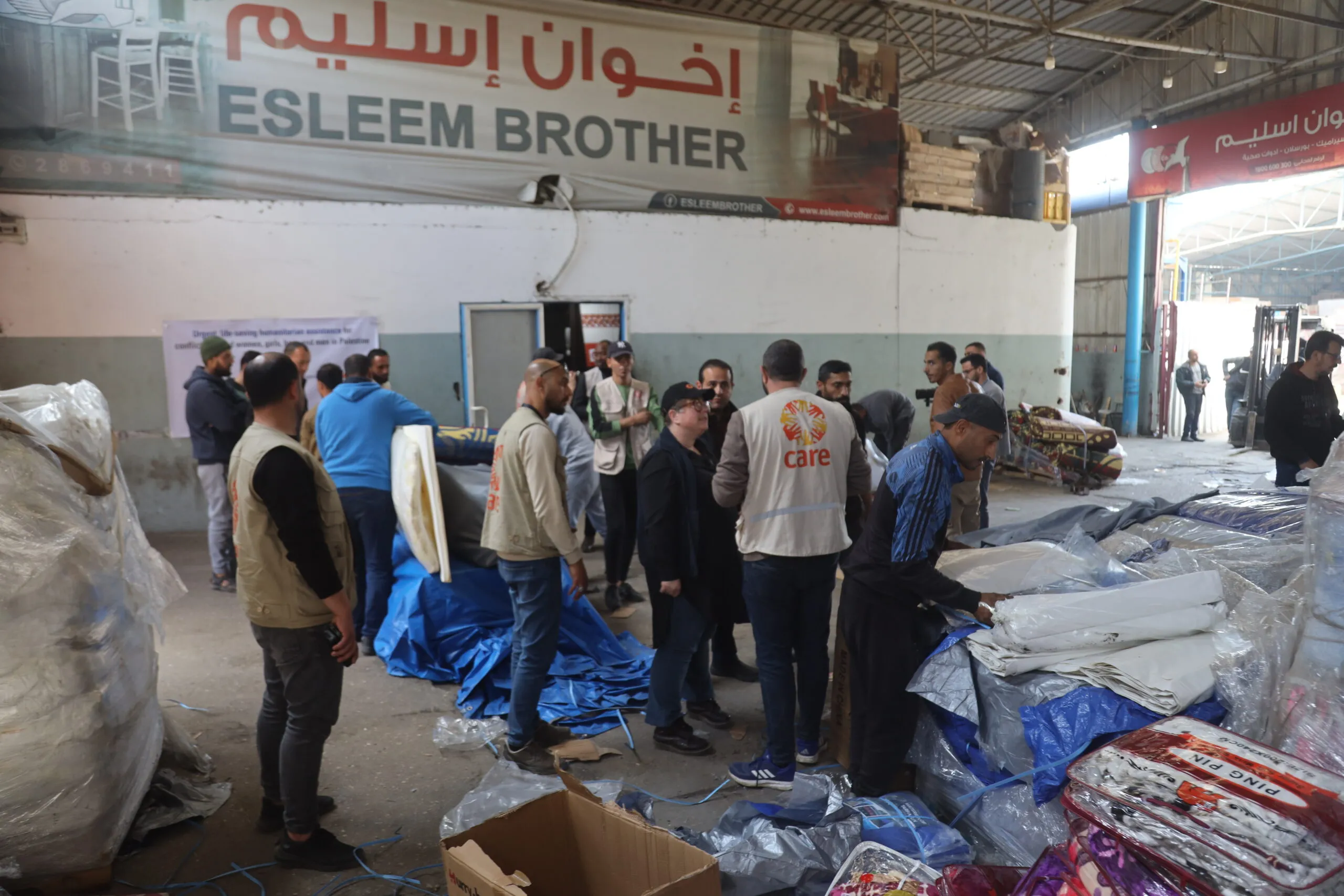 Humanitarian workers organize supplies in a warehouse in North Gaza.